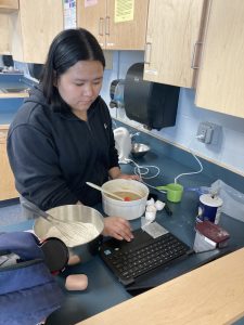 Alisha carefully studied her recipe for blond brownies.